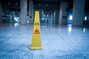 yellow wet floor sign on slippery surface