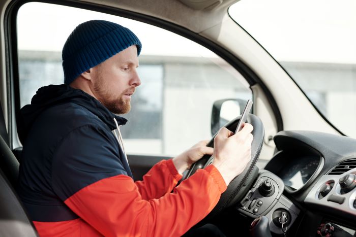 Truck driver violating the distracted driving law.