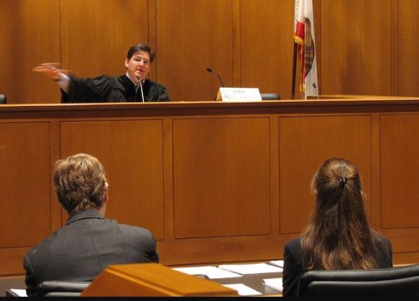 Lawyer representing clients during their first court date.